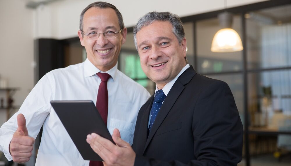 Executives smiling while looking at the camera: Executive Branding