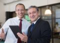 Executives smiling while looking at the camera: Executive Branding