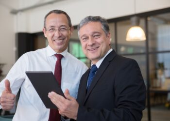 Executives smiling while looking at the camera: Executive Branding