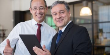 Executives smiling while looking at the camera: Executive Branding