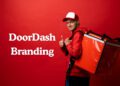 DoorDash branding written while delivery boy posing with delivery bag.